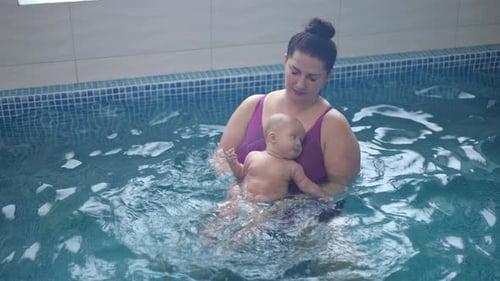 The Mother Accustoms the Infant to Water By Bathing Him in an Infant Pool with Optimal Water