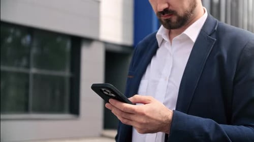 Unrecognizable Bearded Fashion Business Man in Suit Chatting Use Smartphone Outdoor Downtown Office