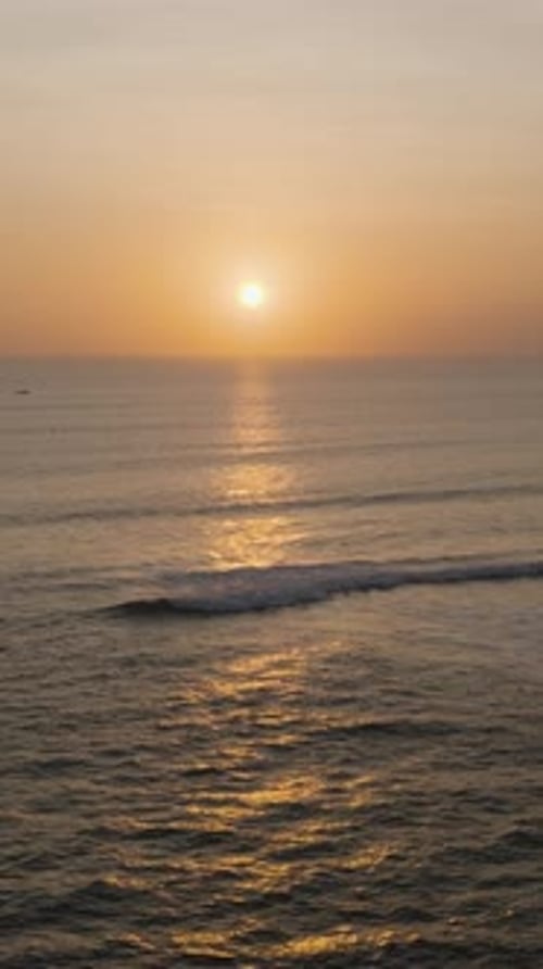Aerial dusk overview of Canggu Beach, Bali, with serene waves and twilight tones