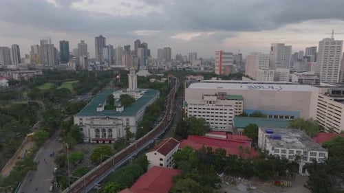 Forwards Fly Above Buildings in Metropolis Train Passing Around City Hall High Rise Downtown