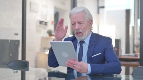 Old Businessman with Loss on Tablet in Office