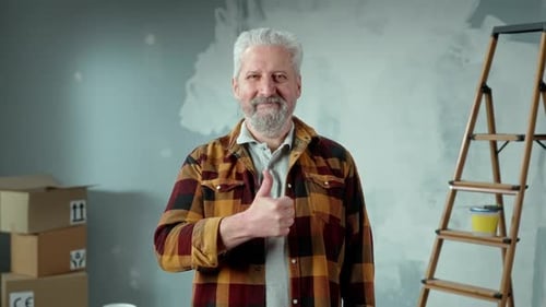Man with Gray Hair Gives a Thumbs Up