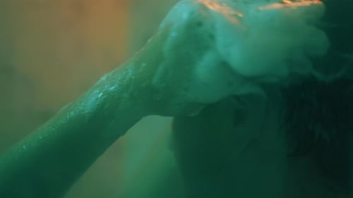 Man Washes Head with Shampoo in Shower