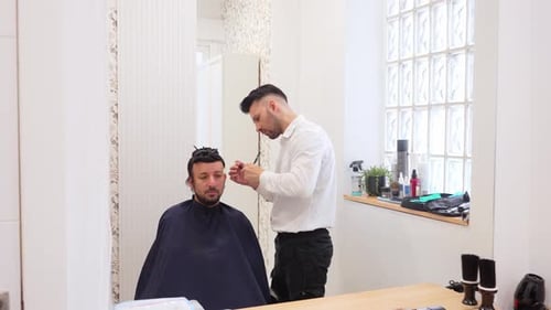 Man Getting Haircut in a Bright Barbershop