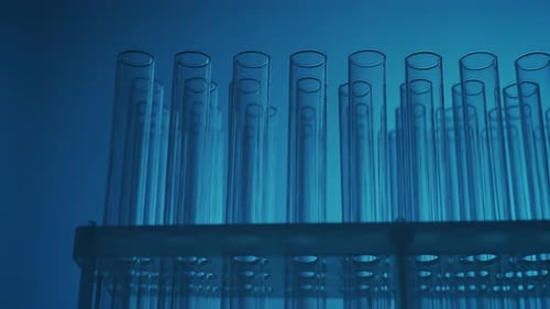 Close Up Video Neon Blue Light Test Tubes in a Laboratory Scientific Experiment Research Study