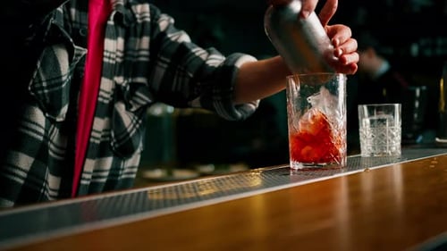 Bartender Preparing a Colorful Cocktail at Night