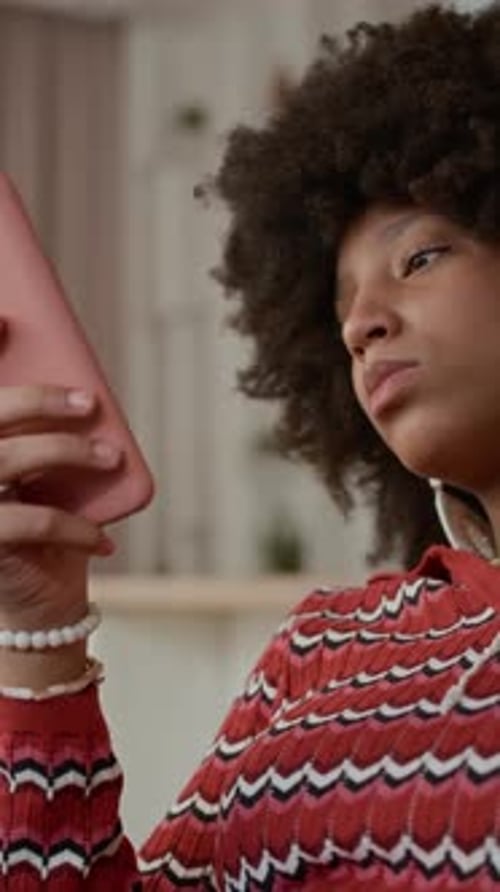 Smiling Person Using Phone With Christmas Tree