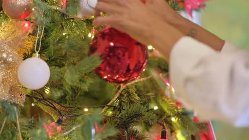 Close up of Woman Decorating Christmas Tree at Home