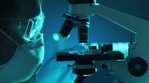 Scientist Using Microscope in Medical Research Lab