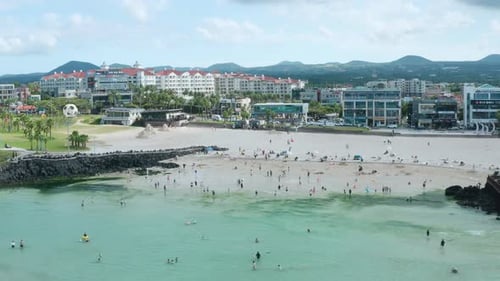 Beach scenery on Jeju Island, South Korea. People vacationing on the beach.