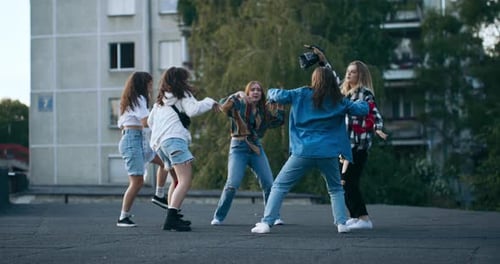 Five Young Women Dancing on a Rooftop