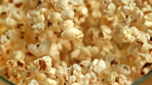 A Bowl of Popcorn Falls on a Yellow Background Filmed on a Highspeed Camera at 1000 Fps
