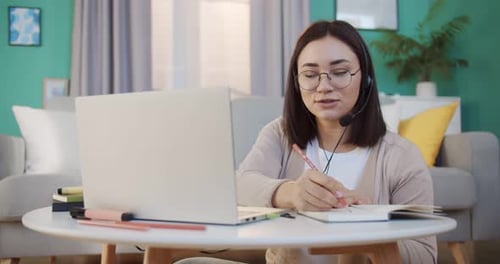 Young Woman Working Remotely at Home Office