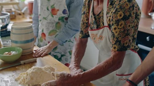 Senior Woman Kneading Dough at Kitchen Counter