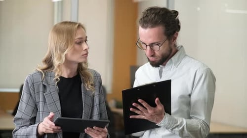 Professional Colleagues Discussing Project in Office Setting