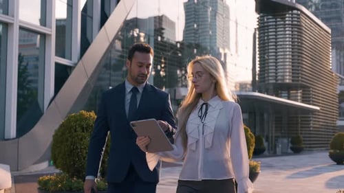 Two Business People Walking and Talking Outdoors Using Digital Table - slow motion waist up shot