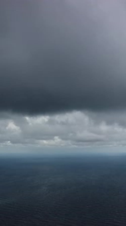 Aerial Vertical View Dramatic Moody and Gloomy Rain Clouds Over Sea Abstract Aerial Nature Summer