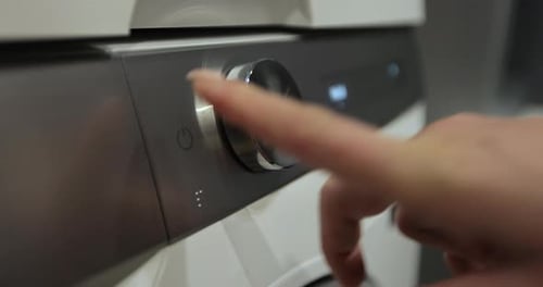 Woman Press the Switch to Make the Washing Machine Work Home Appliances Laundry Setting Washing