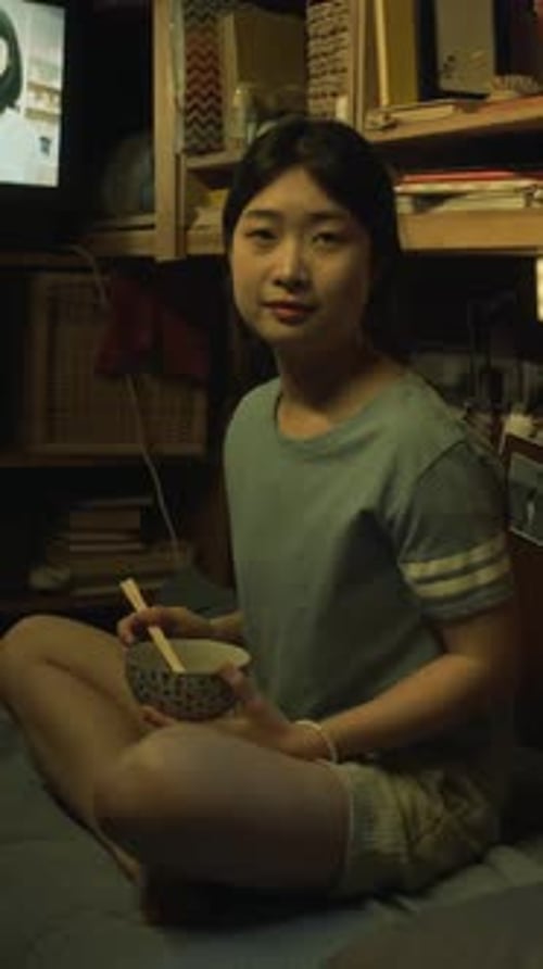 Portrait of Young Asian Female Resident Living in Shoebox Apartment