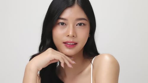 Studio shot of Beautiful young Asian woman with clean fresh skin on white background.