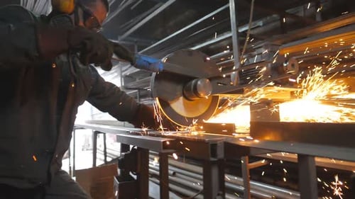 Industrial Worker with Circular Saw Sawing Steel in Workshop Man in Safety Protection Wear Use Saw