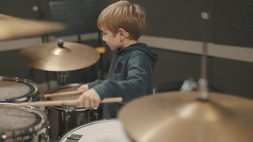 Young Talented Boy Playing Drums in Music Studio
