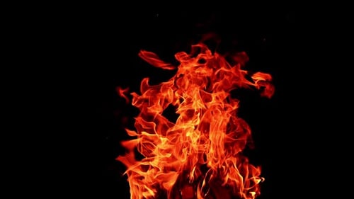 Fire flame on isolated black background. Fire sparks glowing with warm.