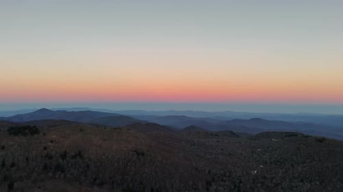 A Serene And Tranquil Mountain Sunset That Beautifully Overlooks An Expansive Landscape