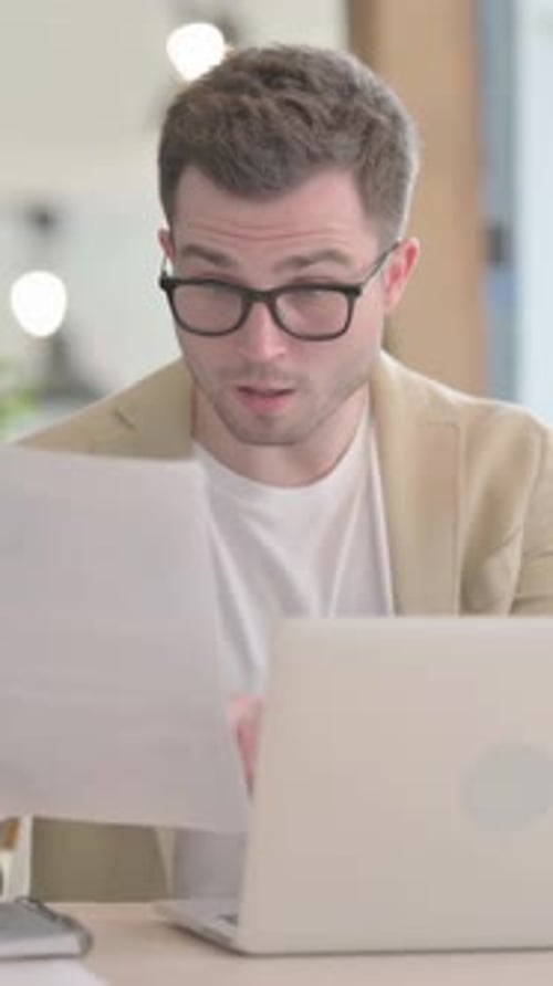 Happy Young Man Celebrating Success in Office