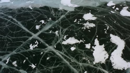 Beautiful pattern of an icy and snow-covered lake in winter.
