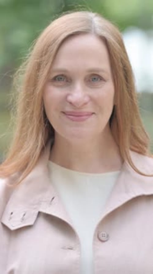 Woman Gives Thumbs Up Approval in Park