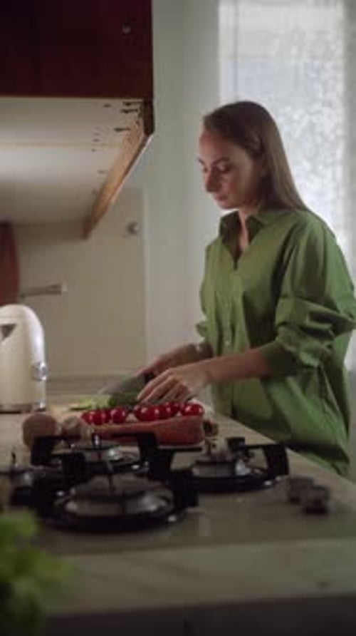 Woman Cutting Vegetables in Bright Kitchen