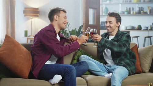 Loving Couple Toasting with Wine on Sofa