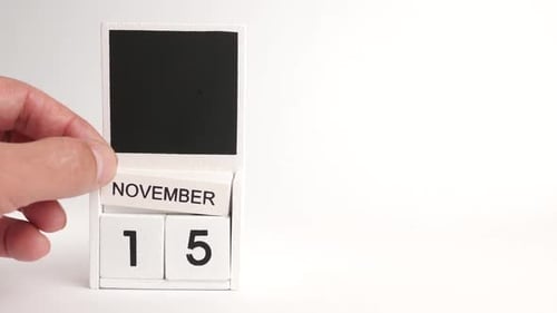 Hand Sets Wooden Calendar to November Fifteenth