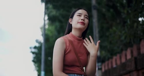 Woman Fanning Herself on a Hot Summer Day