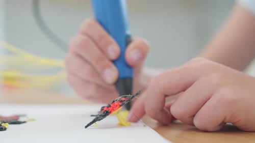 Child Creating Insect With 3D Printing Pen