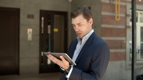 Close Up Serious Businessman Using Tablet Computer for Work Outdoors. Successful Man
