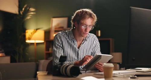 Night, office and man with tablet for editor, photographer or online design with tech