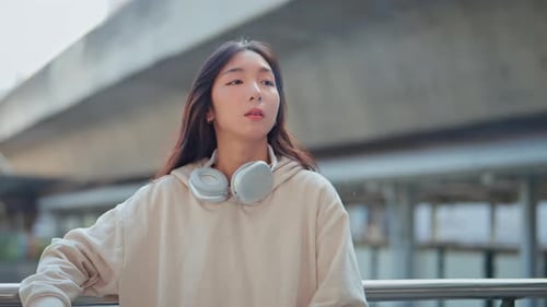 Confident young asian woman smoke electronic cigarette on city outdoors