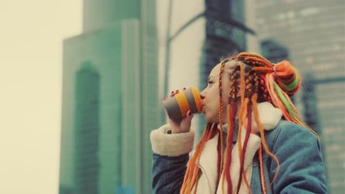 Woman Drinks From Reusable Cup in City