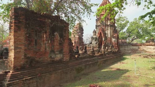 Buddha statue among ruins of the Wat Mahathat in Ayutthaya