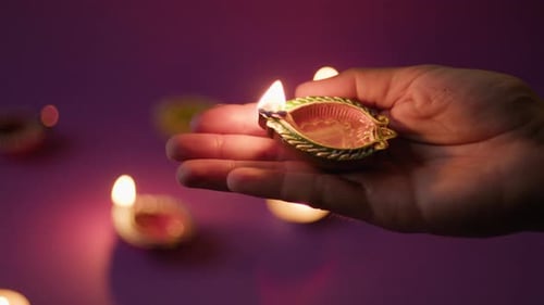 Hand Holding Lit Oil Lamp for Diwali