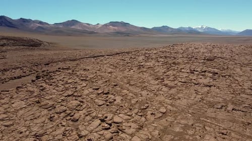 Aerial rises over rugged expansive rocky altiplano in high Bolivia