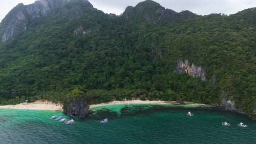 Aerial drone shot of a beach in the mountain in middle of the ocean