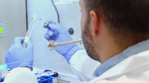 Scientist analyzing test tube in laboratory environment