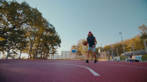 Man Athlete Makes Energetic Jump Shooting Ball Into Hoop