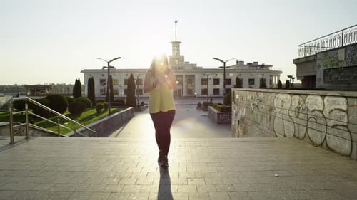 Woman Drinks Water After City Exercise On Stairs