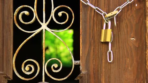 Weathered Door Secured with Chain and Padlock