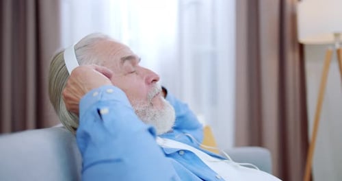 Man Relaxing with Headphones on the Couch