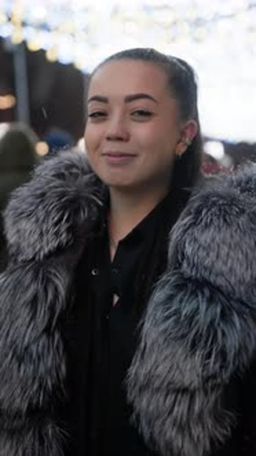 Young Woman in Fur Coat Smiling at Night